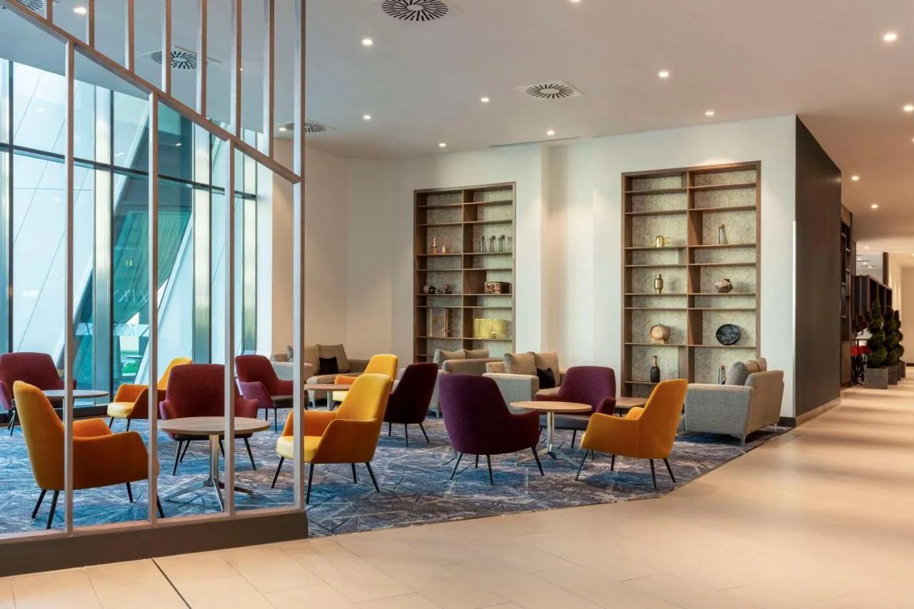 Bright lounge area with tables and chairs at Hilton Aberdeen TECA